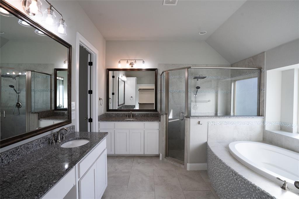 181 Fairview Court Decatur, TX 76234 - Photo 21 of 35 a bathroom with a granite countertop sink a toilet a mirror and shower