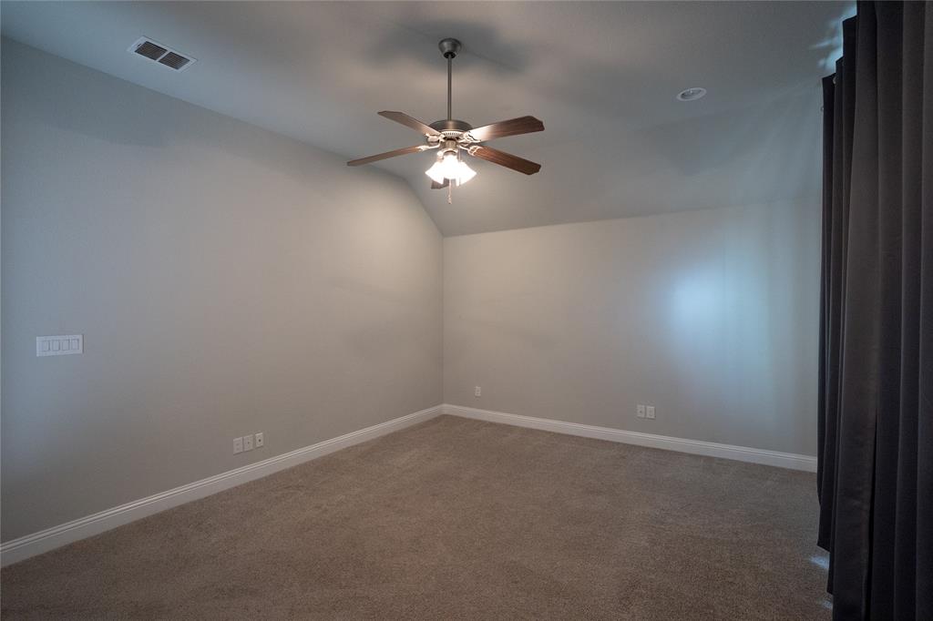 181 Fairview Court Decatur, TX 76234 - Photo 26 of 35 en empty room with windows and fan