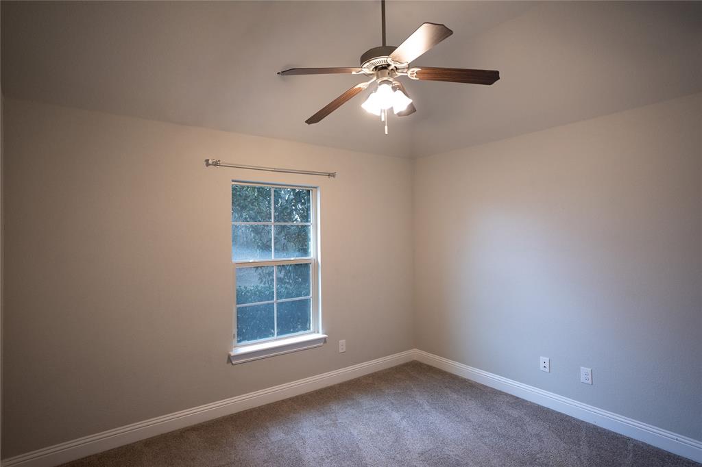 181 Fairview Court Decatur, TX 76234 - Photo 33 of 35 an empty room with windows and fan
