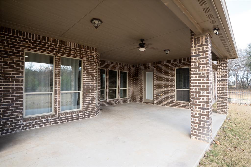 181 Fairview Court Decatur, TX 76234 - Photo 7 of 35 a view of a porch with a table and chairs