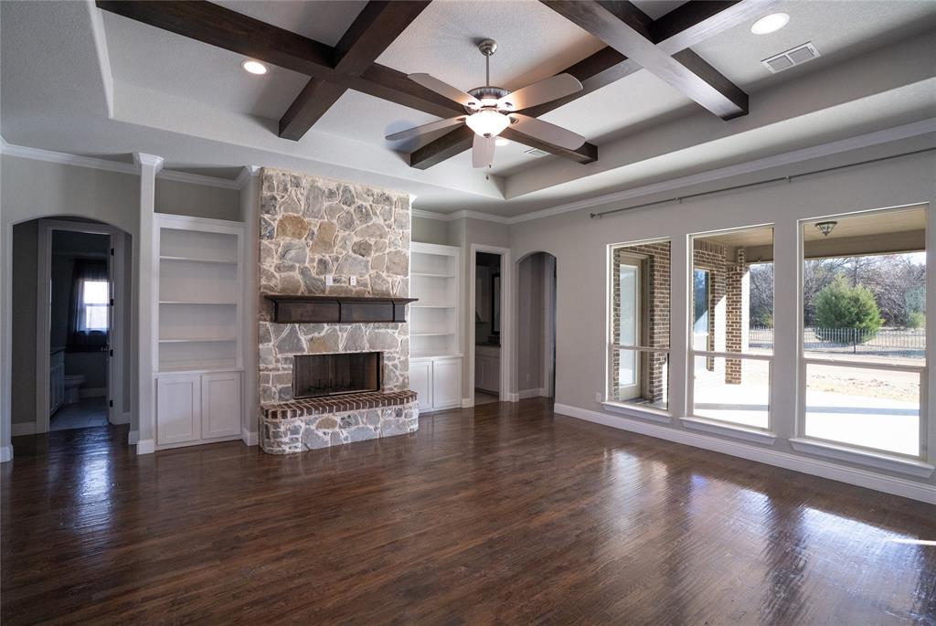 181 Fairview Court Decatur, TX 76234 - Photo 10 of 35 a view of a livingroom with a fireplace a ceiling fan and windows