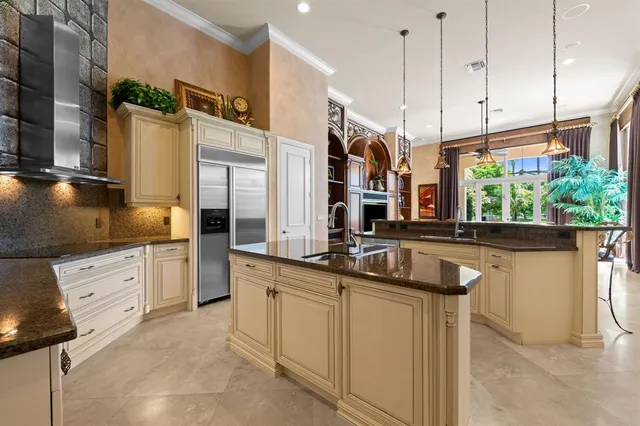 a kitchen with counter top space and living room view