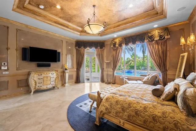 a bedroom with furniture and a flat screen tv