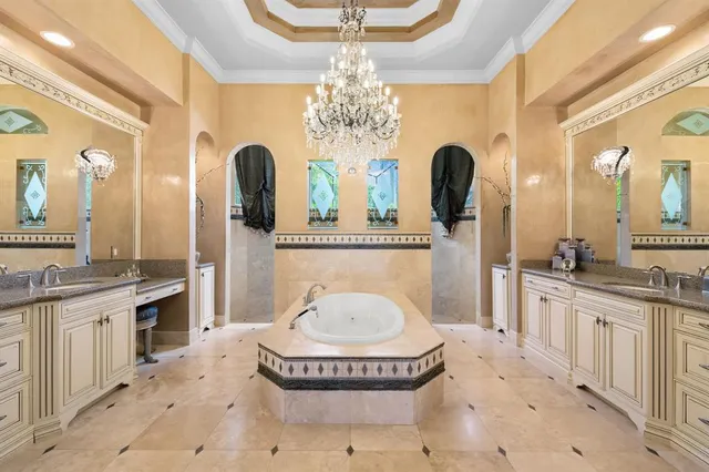 a spacious bathroom with a tub sink and mirror