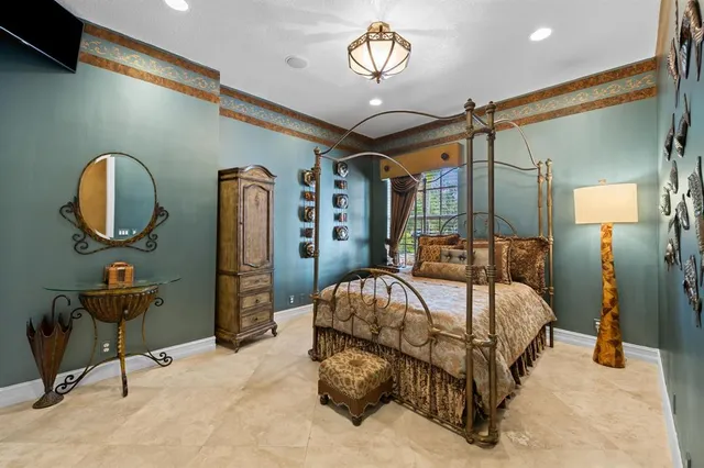 a bedroom with a bed a mirror and furniture