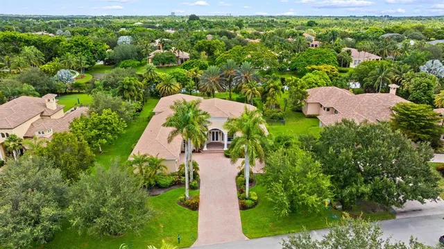 an aerial view of a house with garden space and street view