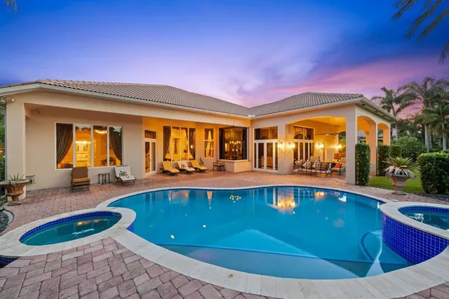 a view of a swimming pool with chairs