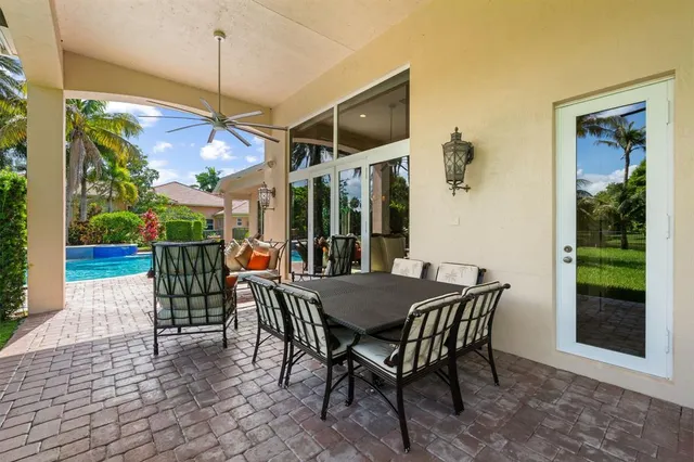 a view of a dining table and chairs in the patio