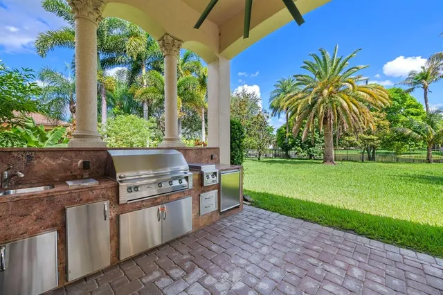a view of a kitchen with a sink and garden