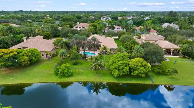 an aerial view of a house with yard swimming pool and outdoor seating