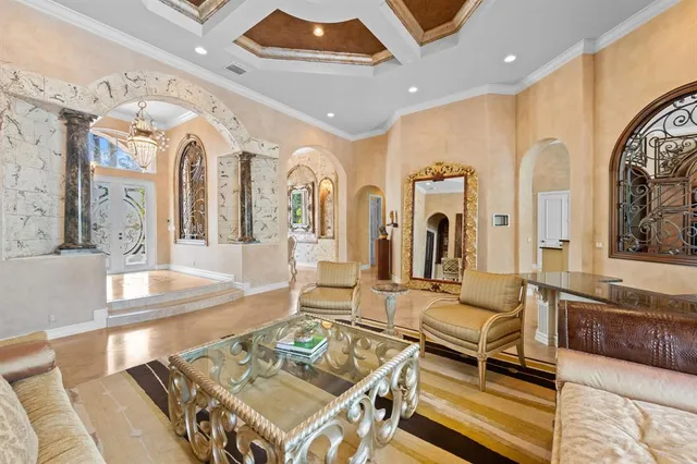 a living room with furniture and a chandelier