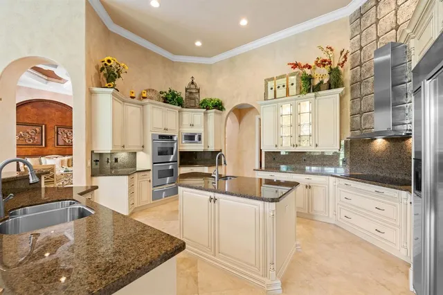 a kitchen with stainless steel appliances granite countertop a sink and a stove