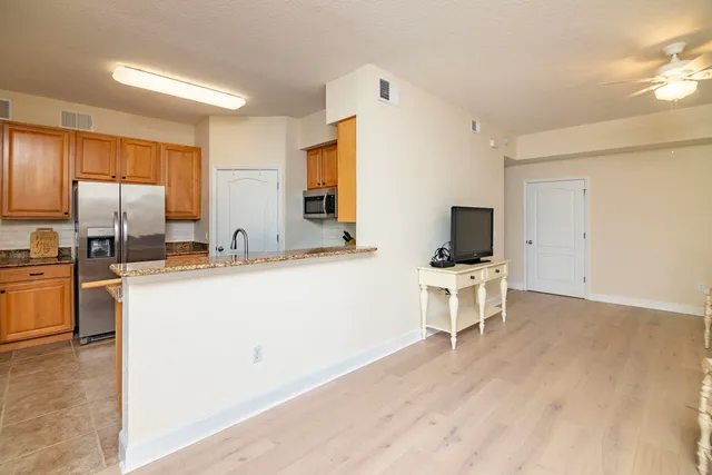 a kitchen with a refrigerator and a stove top oven