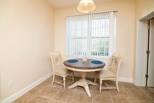 a dining room with furniture and window