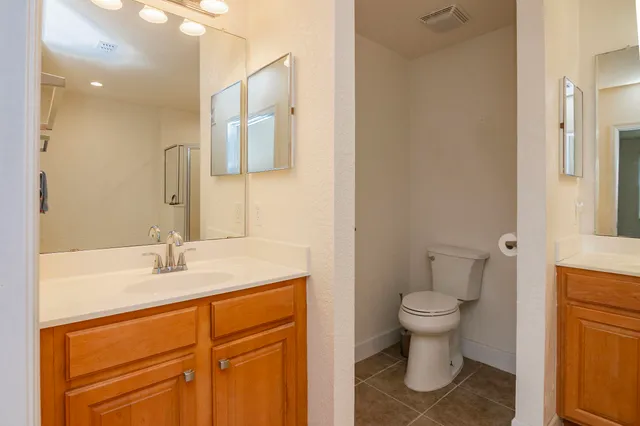 a bathroom with a sink toilet a mirror and vanity
