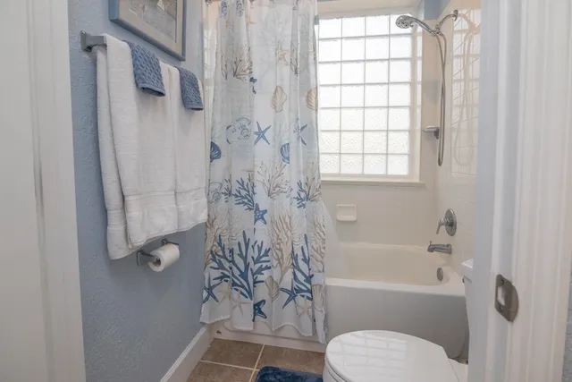 a bathroom with a toilet and a bathtub