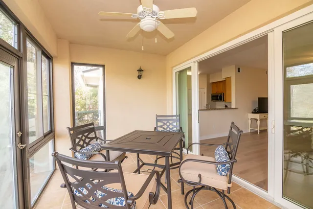 a view of a dining room with furniture and a floor to ceiling window