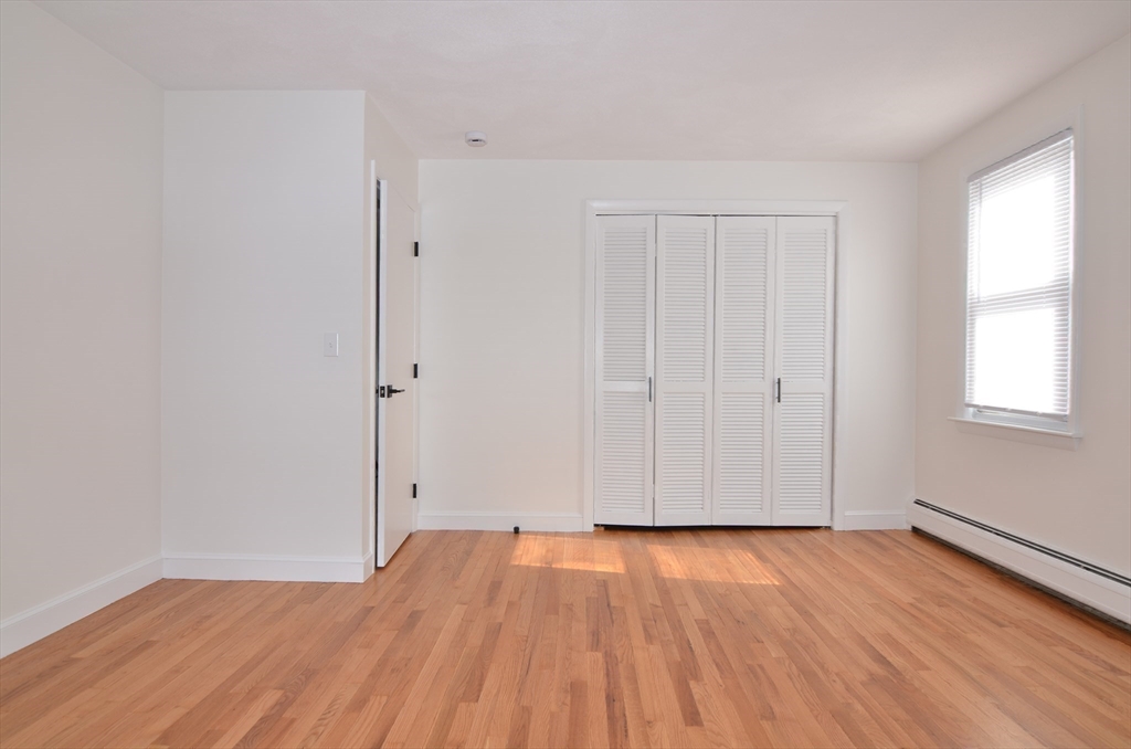 88 Cleveland Avenue, Unit 2 Everett, MA 02149 - Photo 15 of 23 a view of empty room with wooden floor and fan