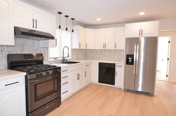 a kitchen with a stove sink and refrigerator
