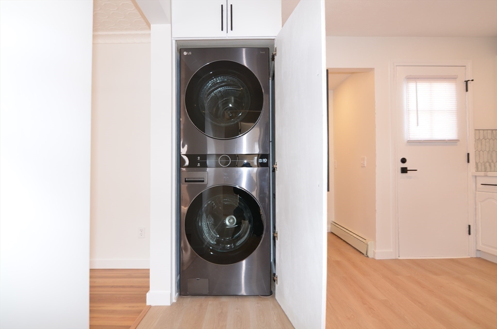 88 Cleveland Avenue, Unit 2 Everett, MA 02149 - Photo 21 of 23 a view of a hallway with washer and dryer