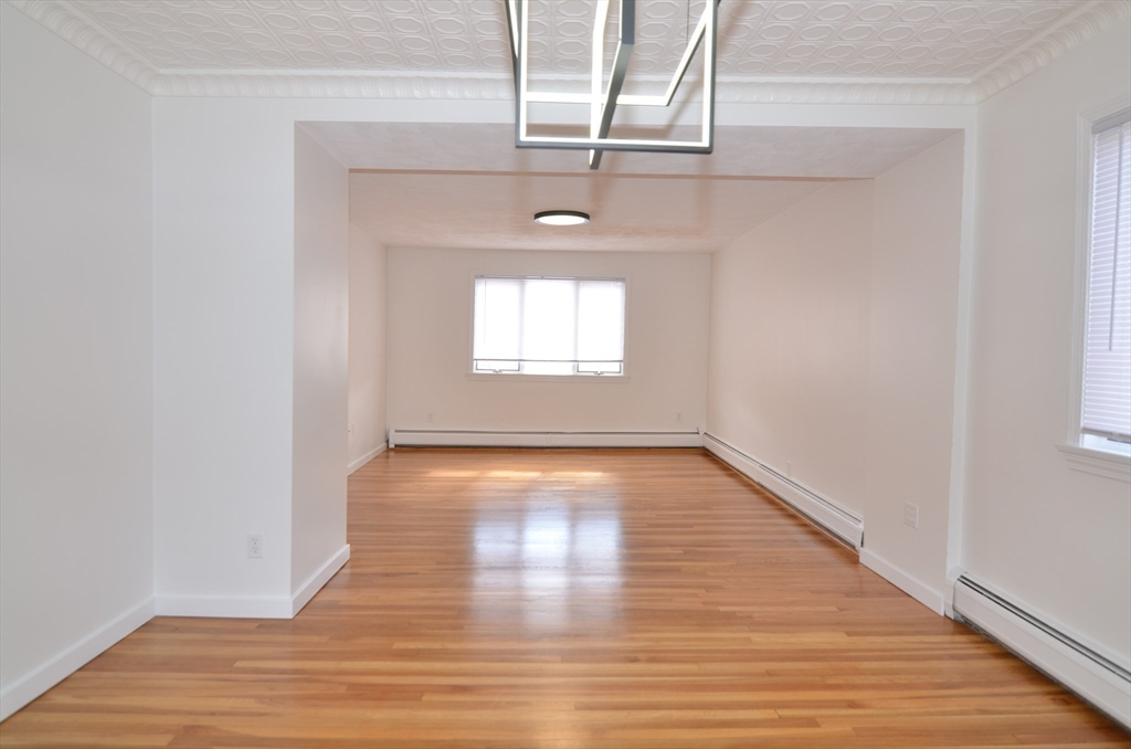 88 Cleveland Avenue, Unit 2 Everett, MA 02149 - Photo 6 of 23 a view of empty room with wooden floor and fan