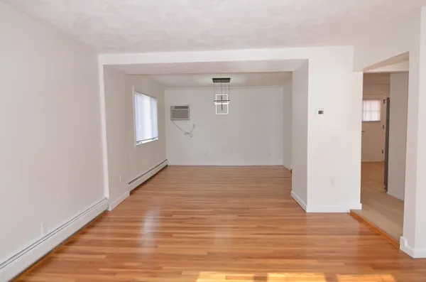 a view of hallway with wooden floor