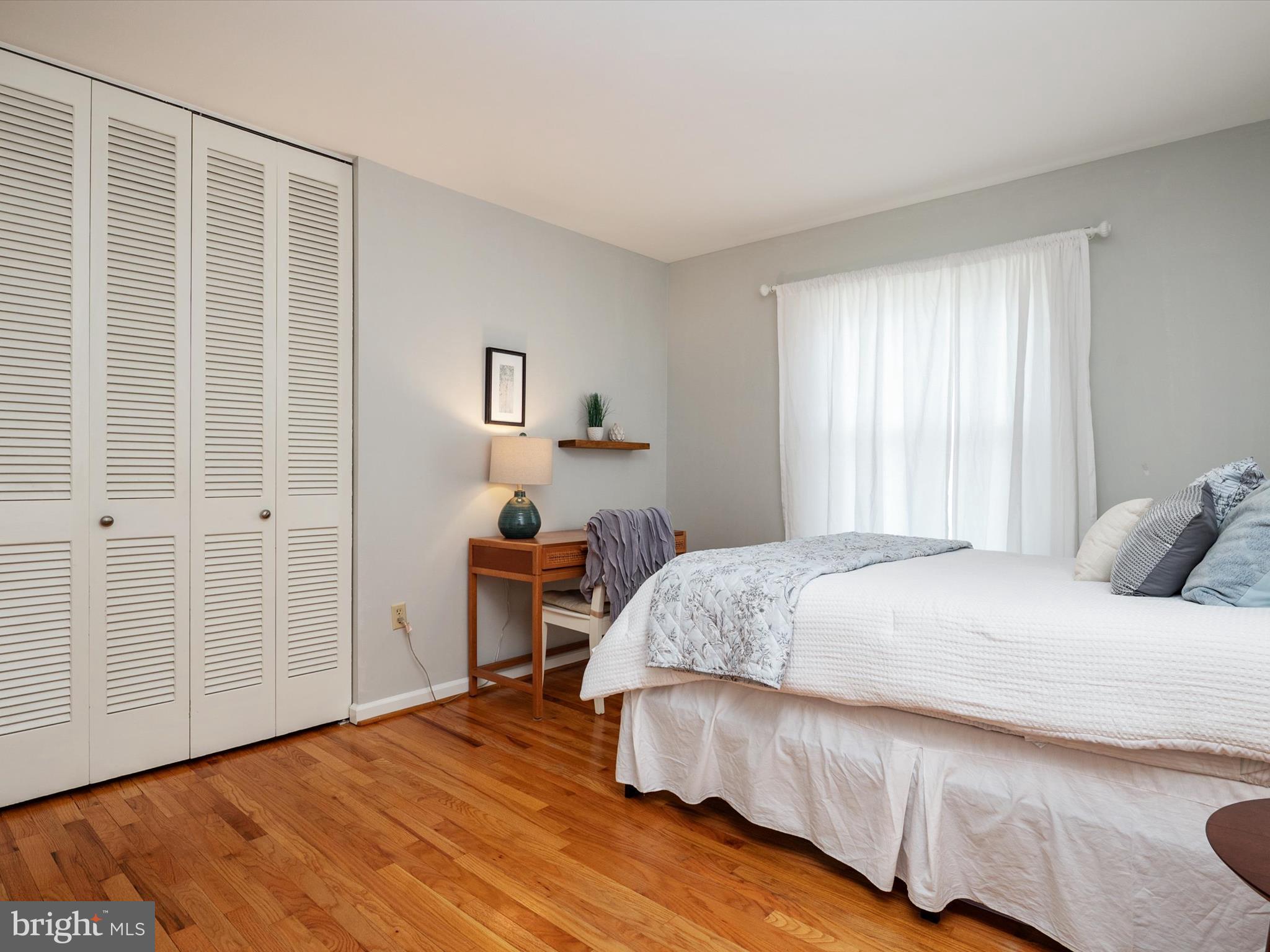 1589 Crofton Parkway Crofton, MD 21114 - Photo 20 of 60 a bedroom with a bed and wooden floor