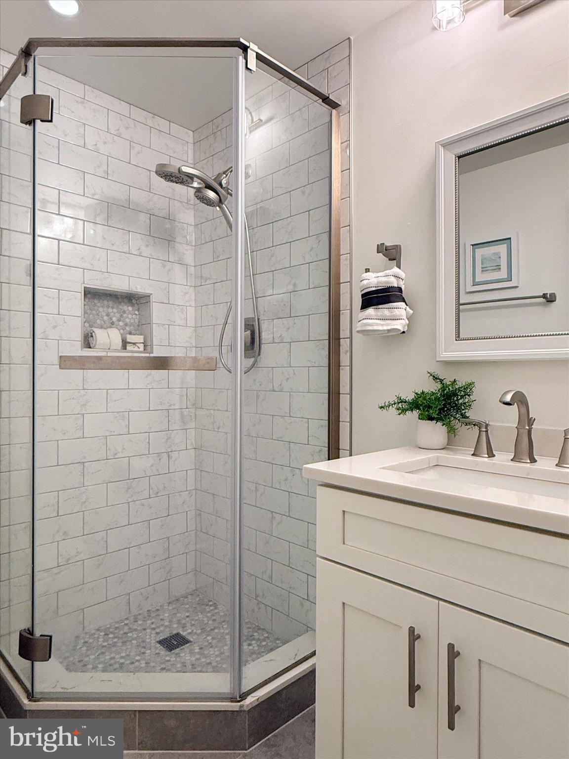 1589 Crofton Parkway Crofton, MD 21114 - Photo 28 of 60 a bathroom with a shower and a sink a mirror