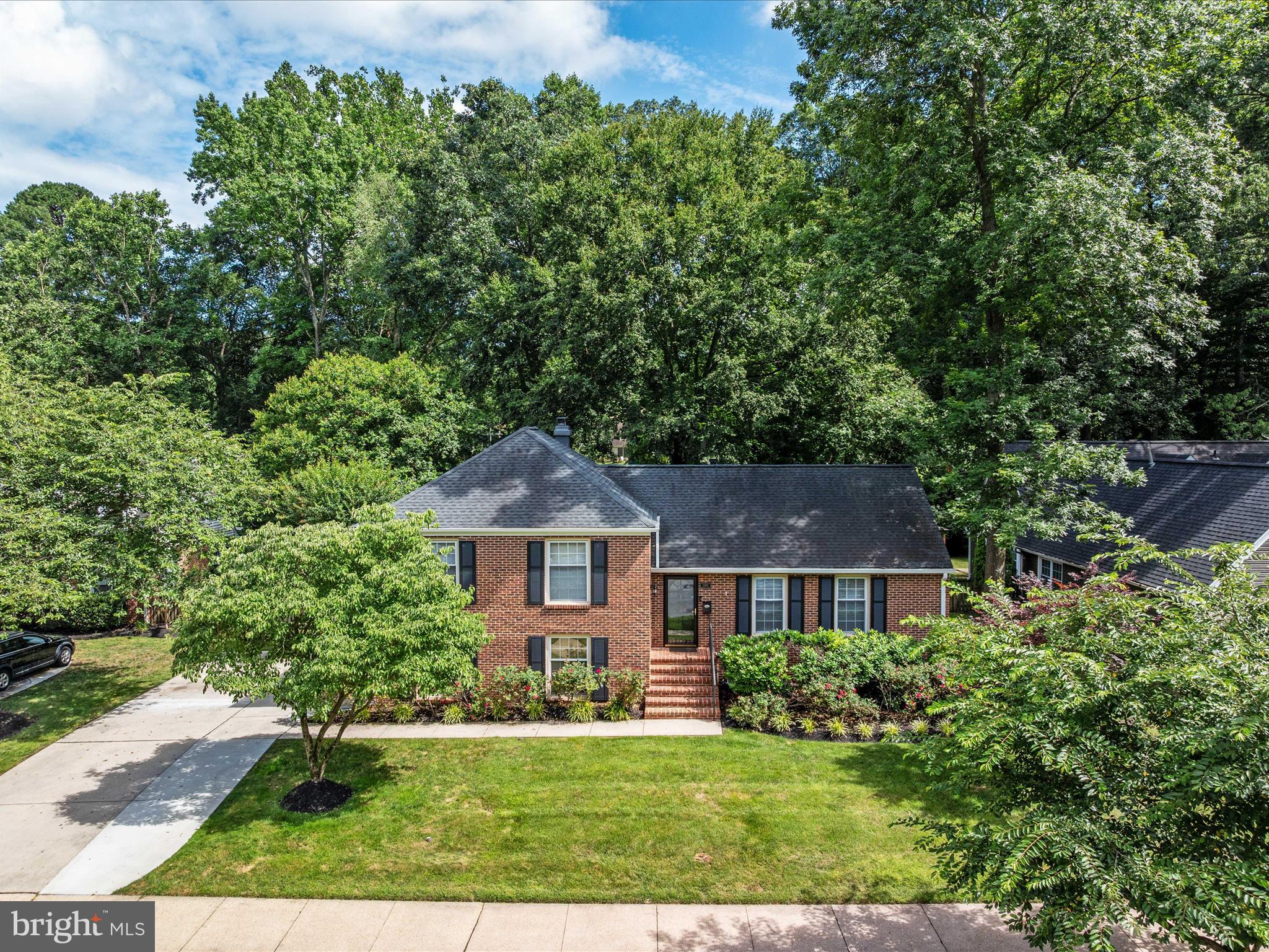 1589 Crofton Parkway Crofton, MD 21114 - Photo 42 of 60 a front view of a house with a yard