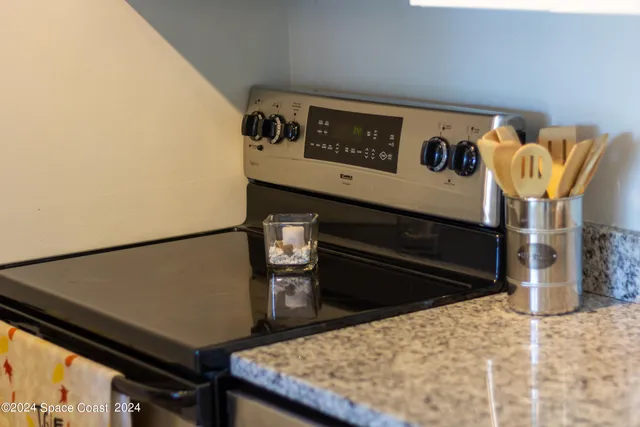 a kitchen with granite countertop cabinets stainless steel appliances a sink and a counter top space