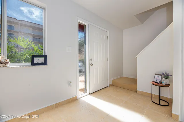 a bedroom with a bed and a potted plant