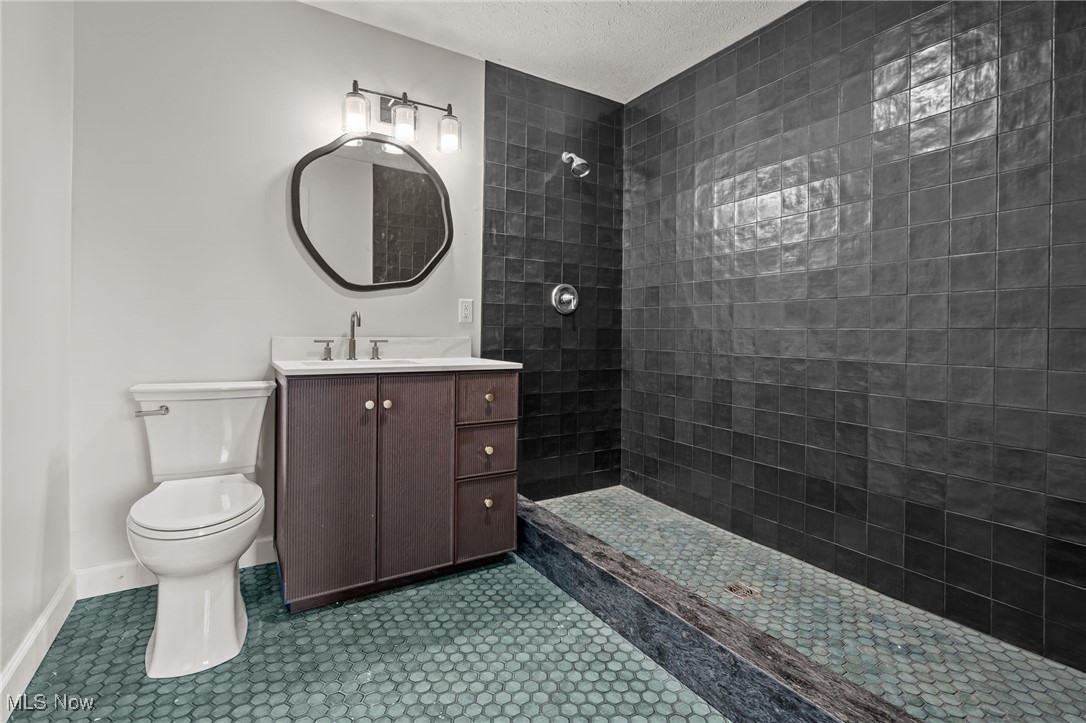 1043 Krumroy Road Akron, OH 44306 - Photo 18 of 48 Gorgeous ceramic tile in the primary bathroom