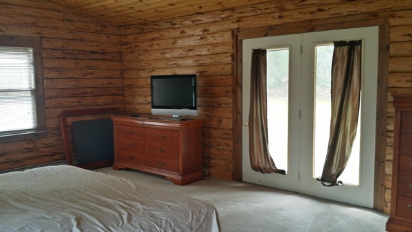 1 Breakneck Road Sturbridge, MA 01566 - Photo 23 of 30 a bedroom with a bed and a flat screen tv