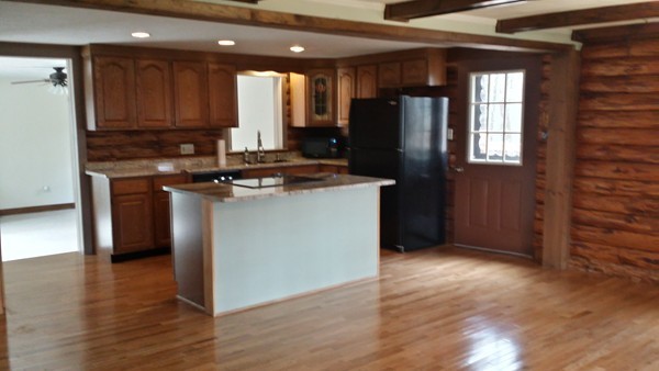 1 Breakneck Road Sturbridge, MA 01566 - Photo 7 of 30 a kitchen with kitchen island granite countertop wooden cabinets and a refrigerator