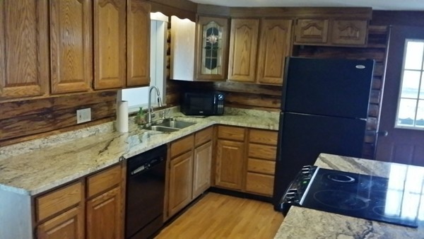 1 Breakneck Road Sturbridge, MA 01566 - Photo 9 of 30 a kitchen with stainless steel appliances granite countertop wooden cabinets a sink and dishwasher