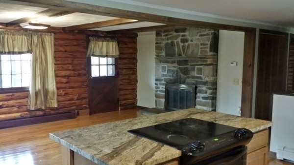 1 Breakneck Road Sturbridge, MA 01566 - Photo 10 of 30 a bed sitting in a lobby next to a window