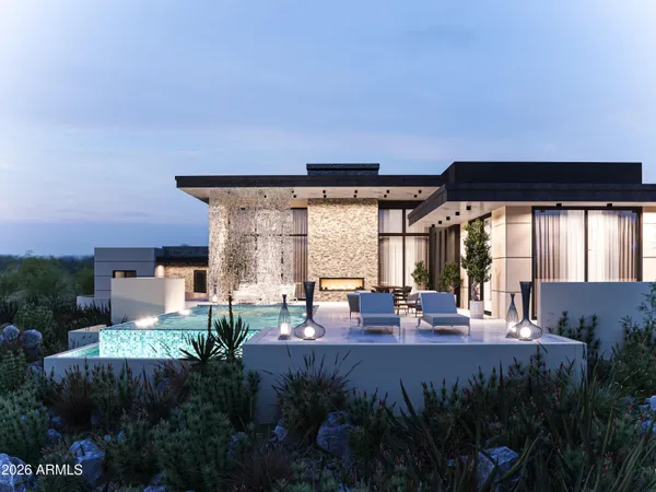 a front view of a house with a yard and garden