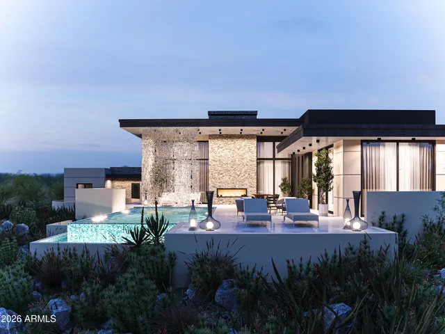 a front view of a house with a yard and garden