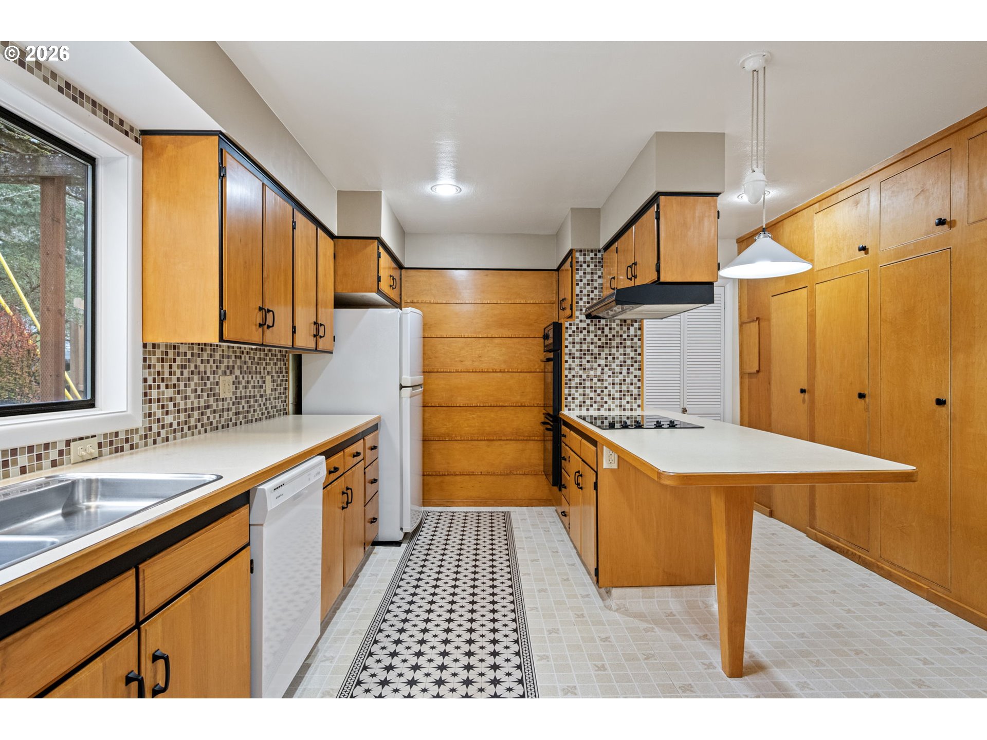 75 West 35th Place Eugene, OR 97405 - Photo 10 of 48 a large kitchen with a sink and wooden cabinets