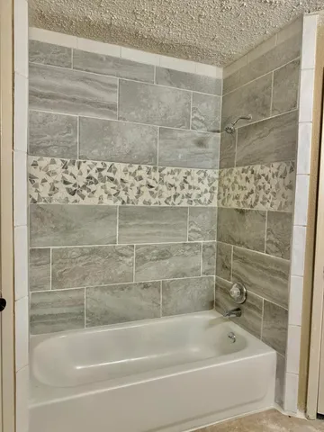 a bathroom with a shower and a bathtub