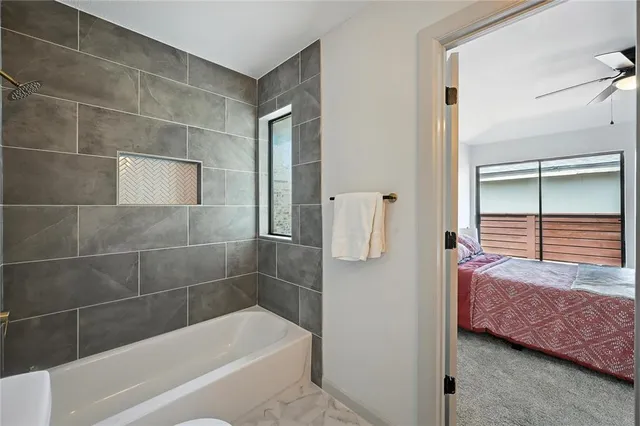 a bathroom with a tub and shower