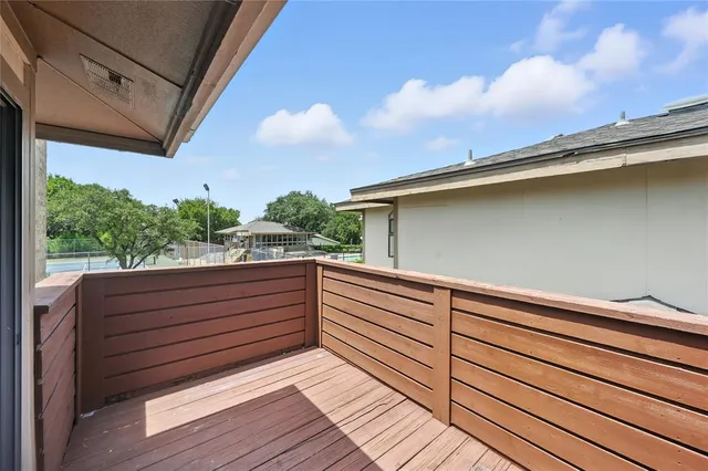 a view of the balcony with wooden floor