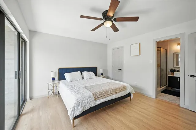 a bedroom with a bed and a ceiling fan