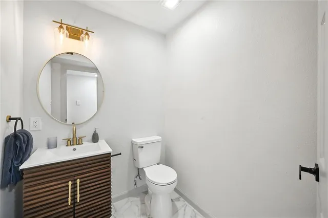 a bathroom with a sink toilet and a mirror