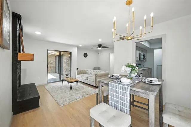 a living room with furniture a chandelier and a dining table