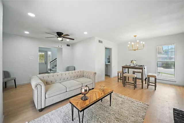 a living room with furniture and a dining table