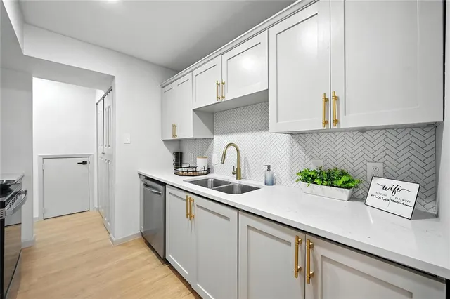 a kitchen with sink and cabinets