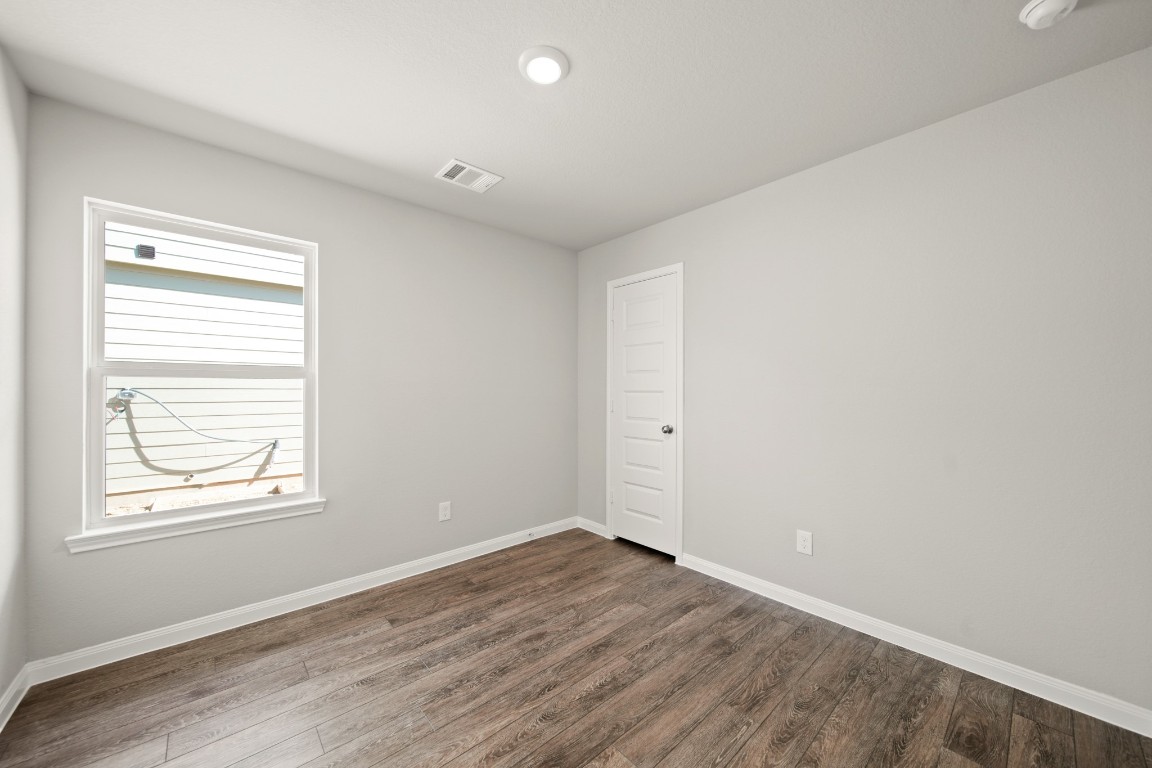 13655 Kit Run Splendora, TX 77372 - Photo 13 of 25 an empty room with wooden floor and windows