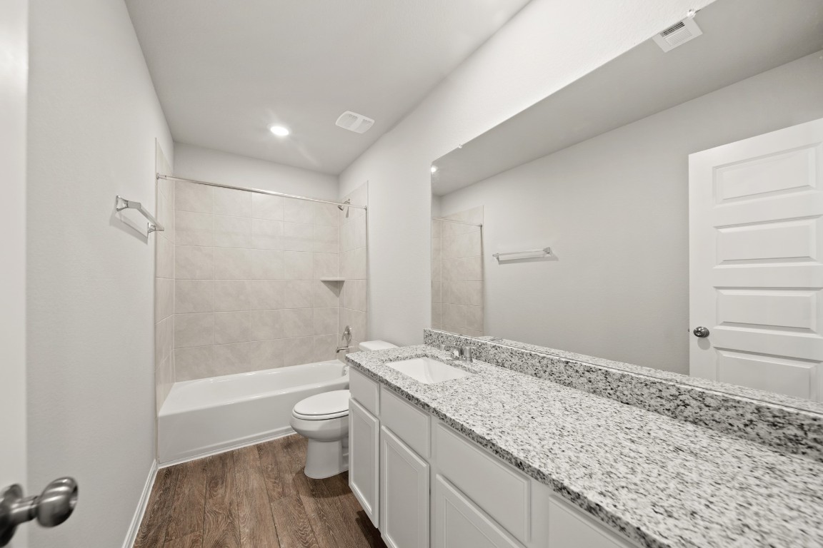 13655 Kit Run Splendora, TX 77372 - Photo 14 of 25 a bathroom with a granite countertop sink a toilet and shower