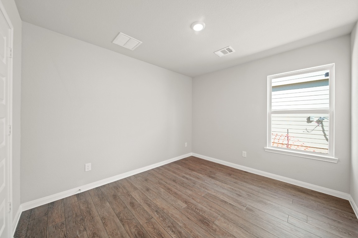 13655 Kit Run Splendora, TX 77372 - Photo 15 of 25 an empty room with wooden floor and windows